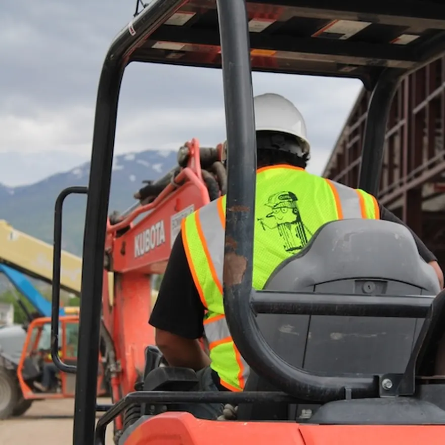 Operator in a Cook vest running equipment